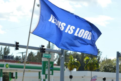 a blue flag with the words "Jesus is Lord"